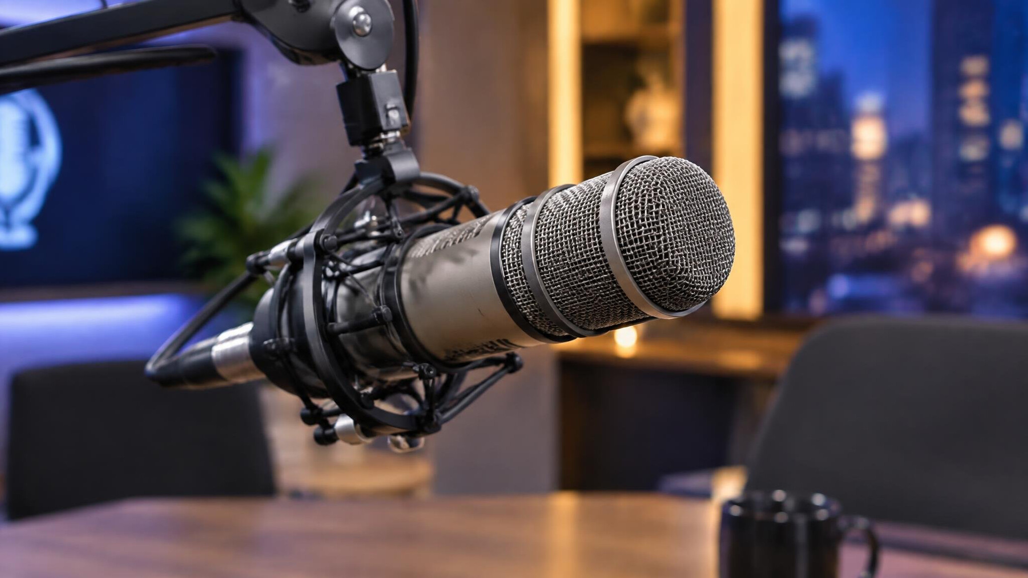 Close up of a broadcast microphone on a boom arm in a studio